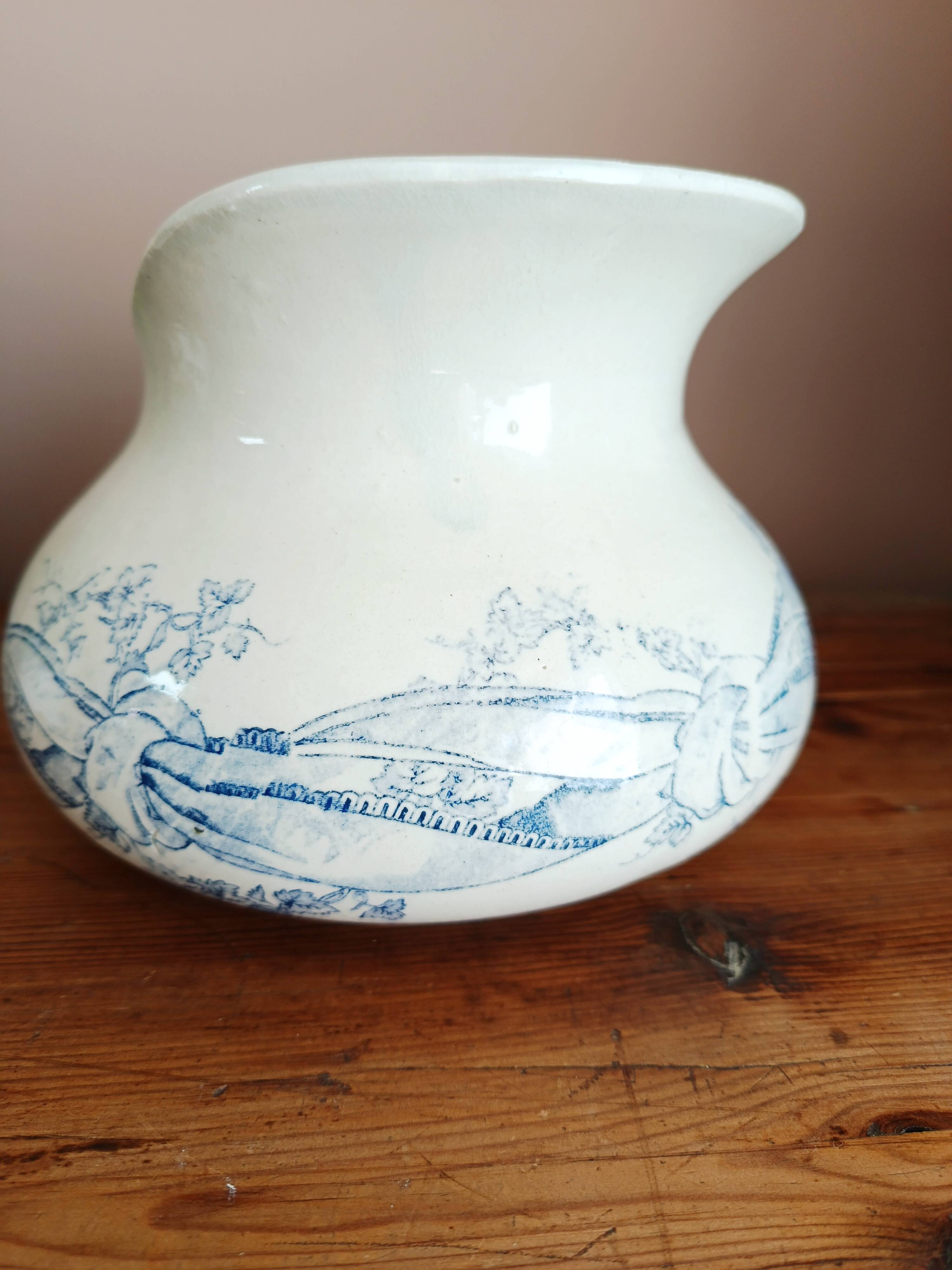 Old bulbous jug in ironstone earthenware