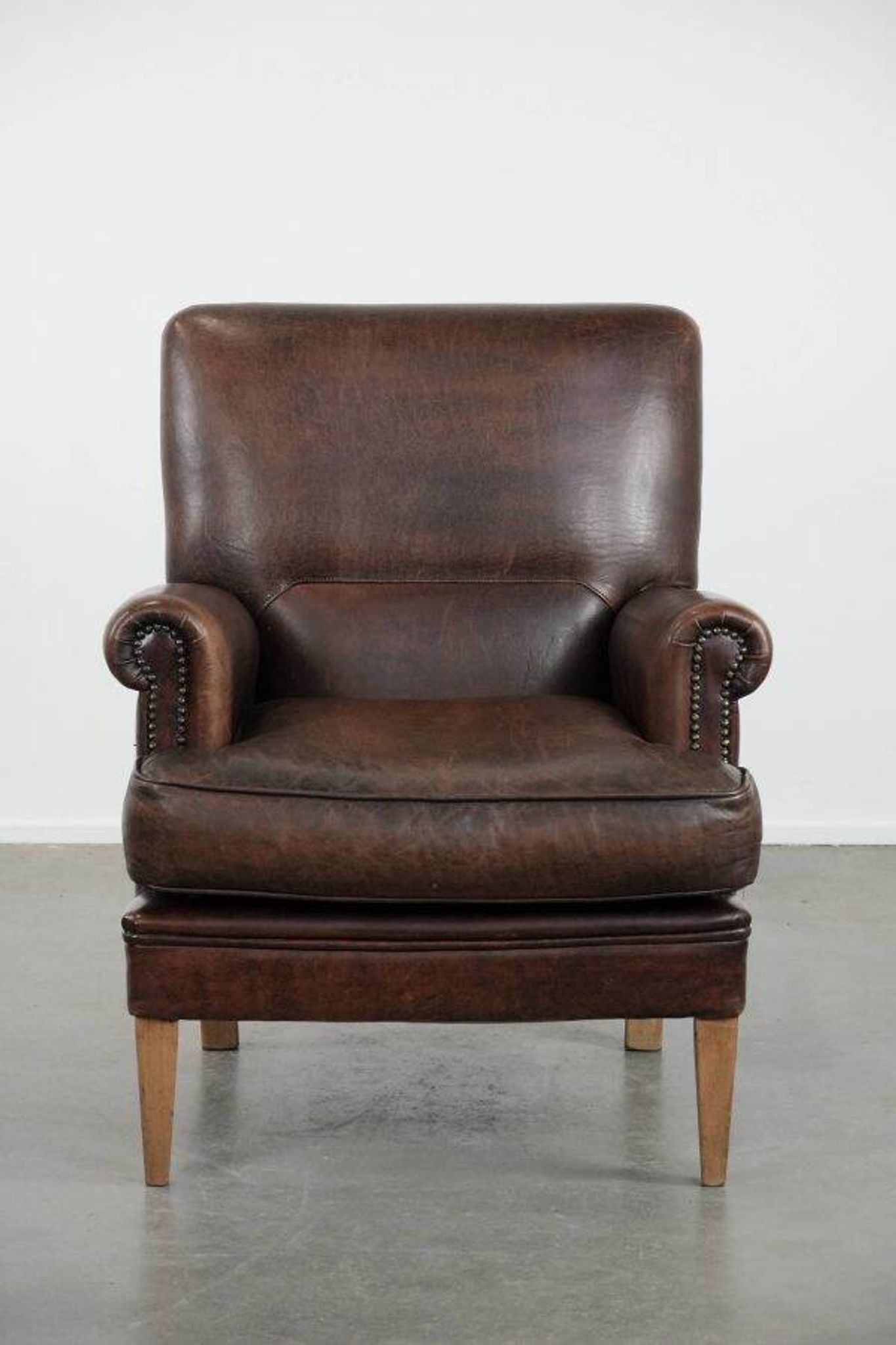 Characterful sheep leather armchair with a beautiful deep colour
