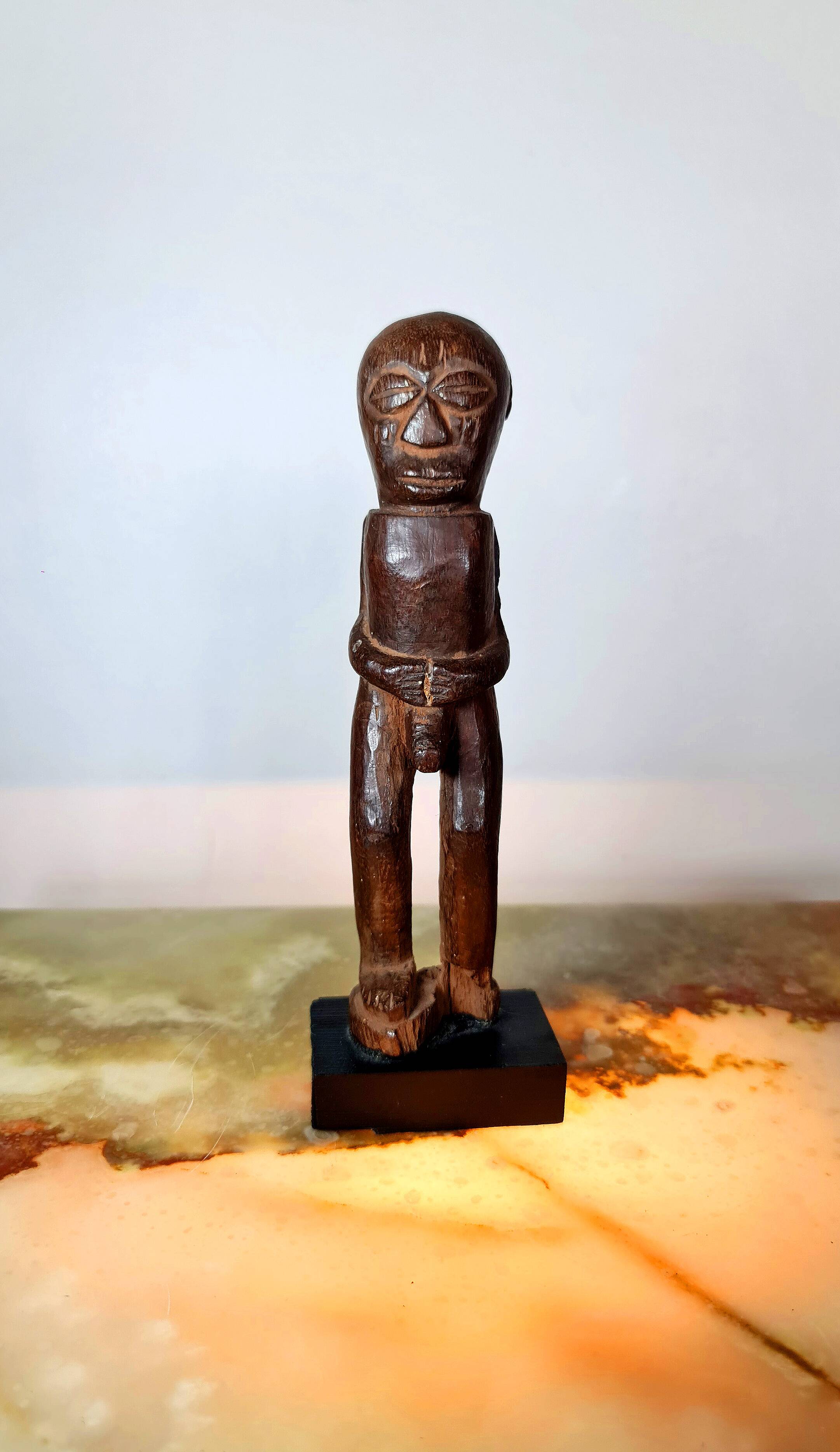 Old Fon statuette on a base, Benin