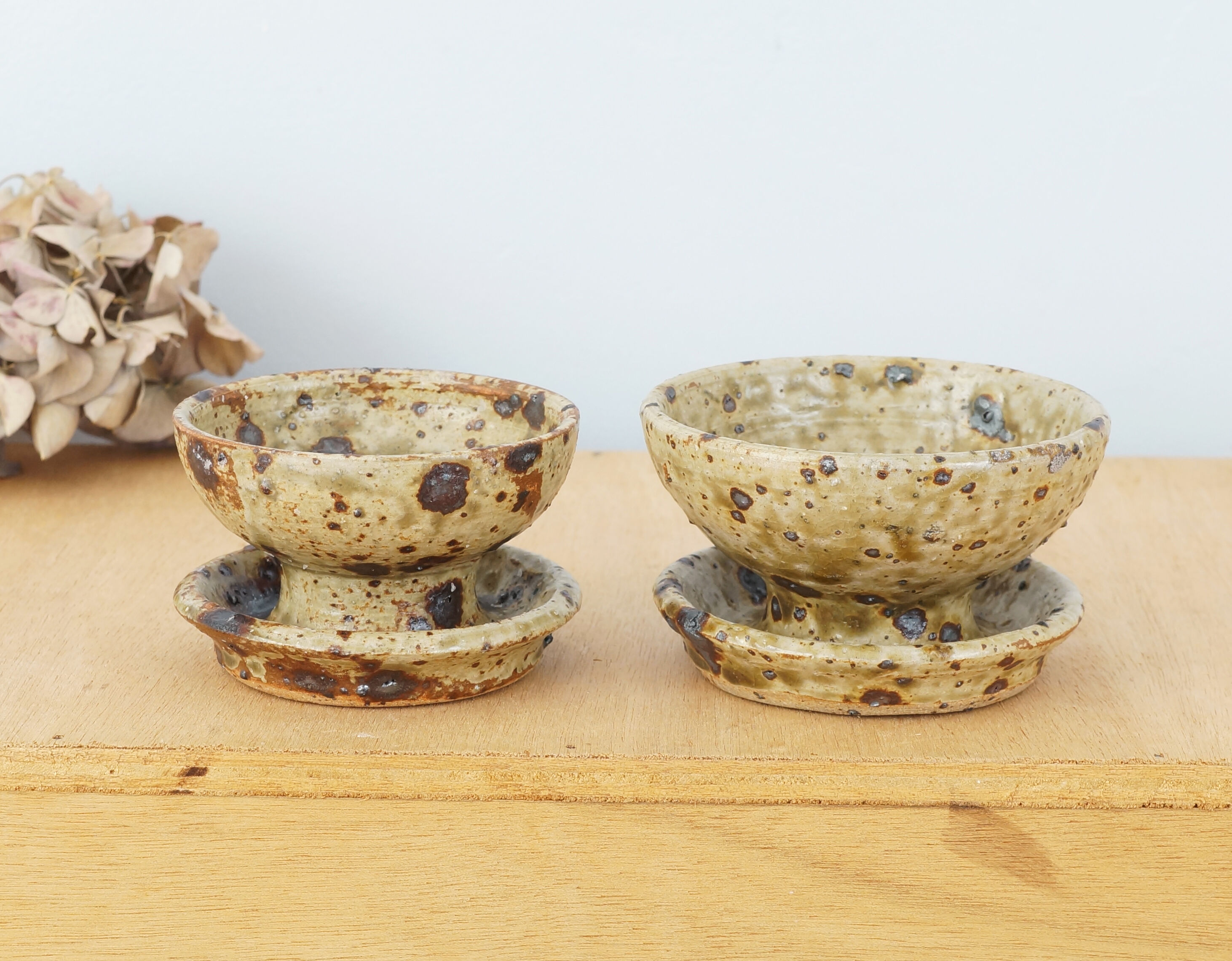 Pair of vergy speckled sandstone candle holders, vintage