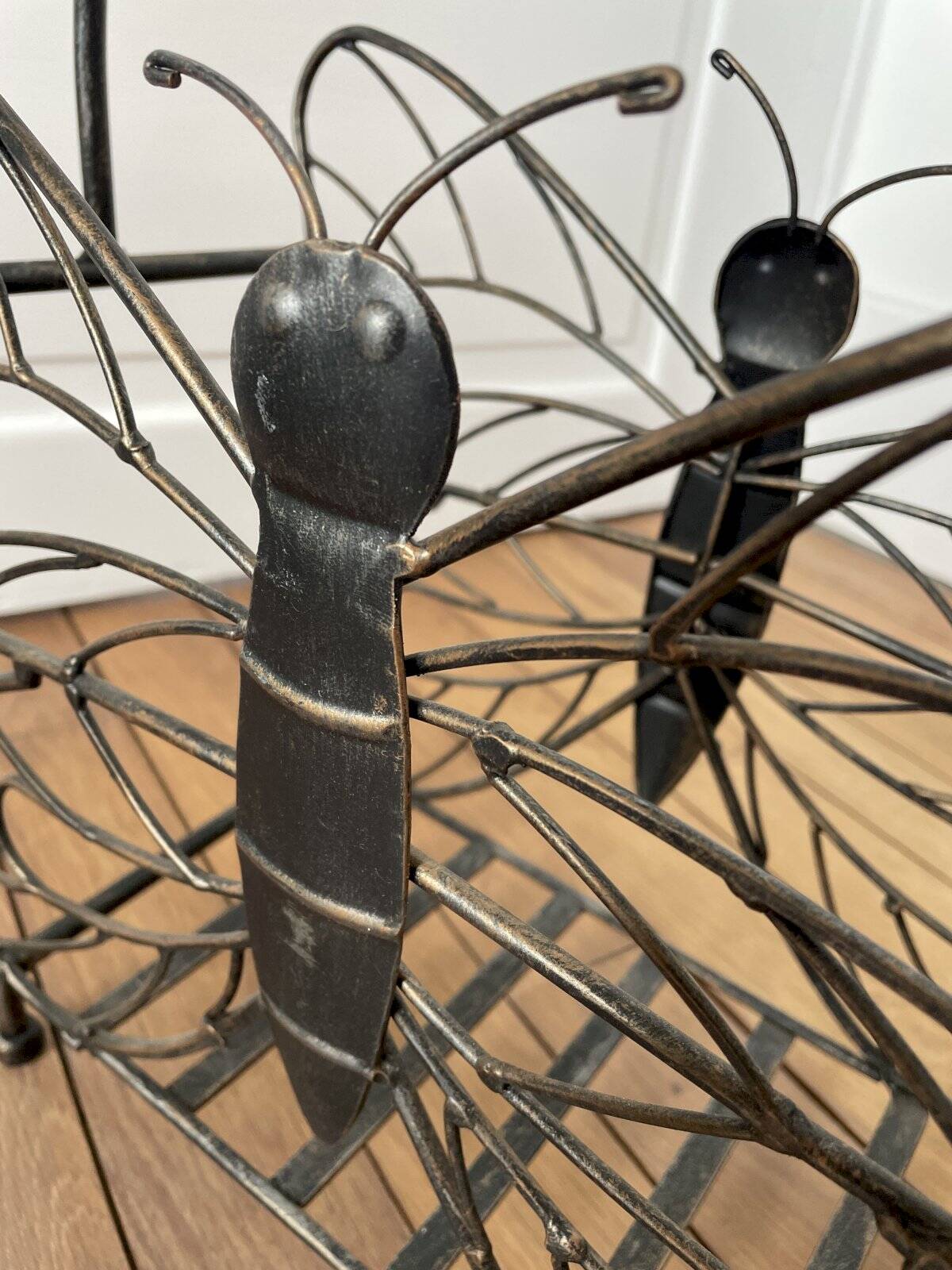 Butterfly magazine rack in patinated metal