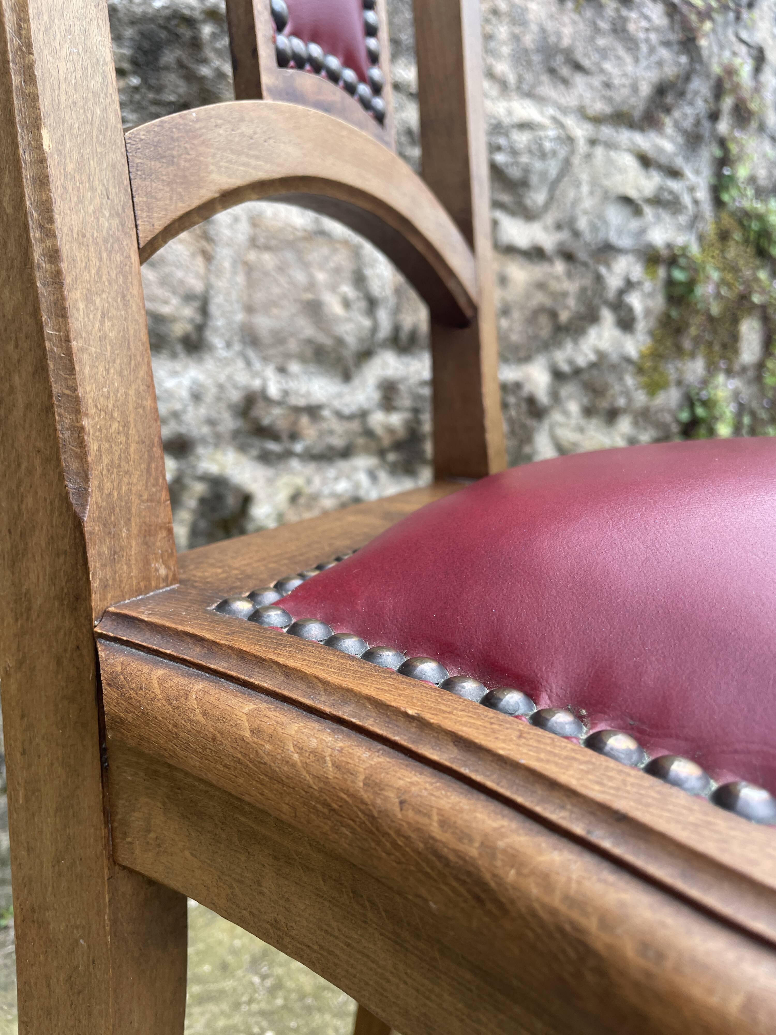 Pair of studded burgundy leather Art Deco chairs