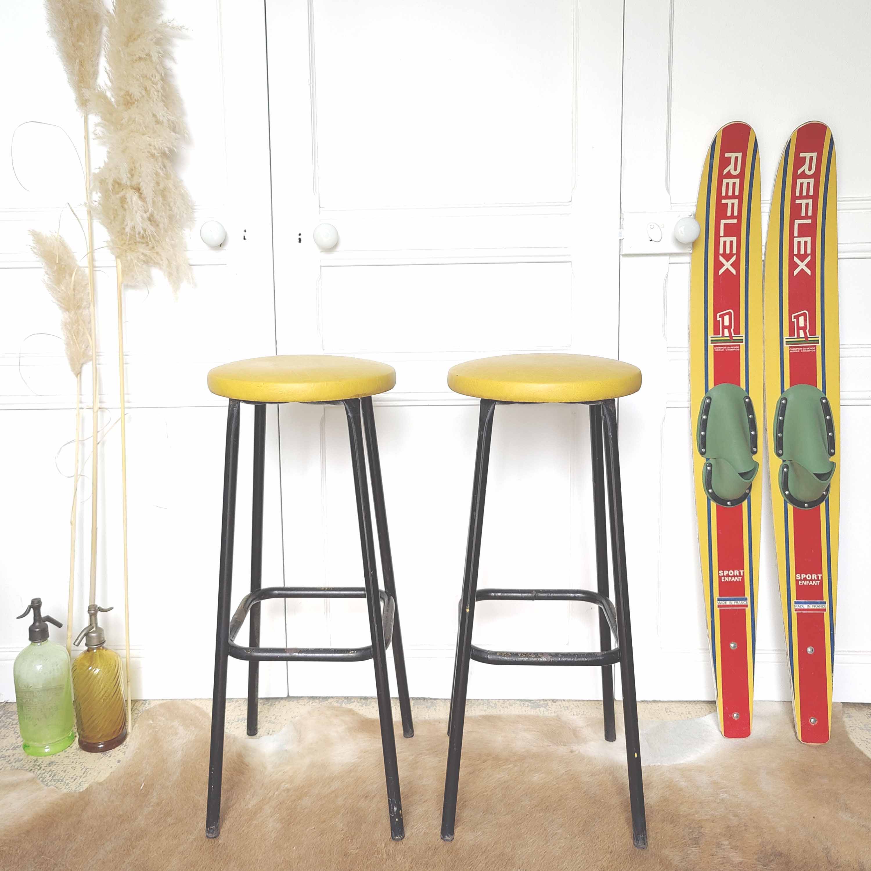 Pair of black metal bar stools and yellow imitation leather seat