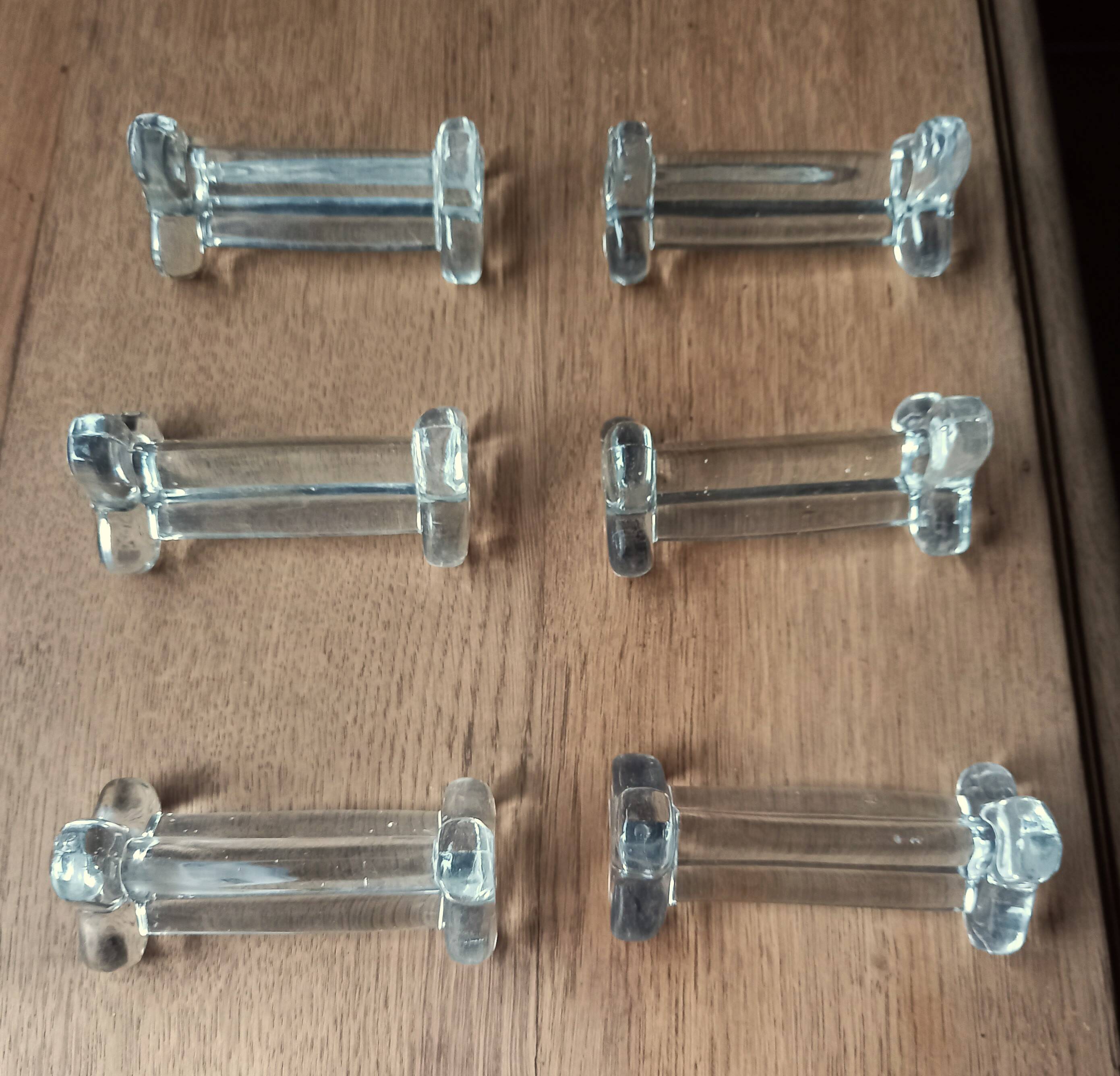 A set of 6 antique transparent trilobed glass knife holders