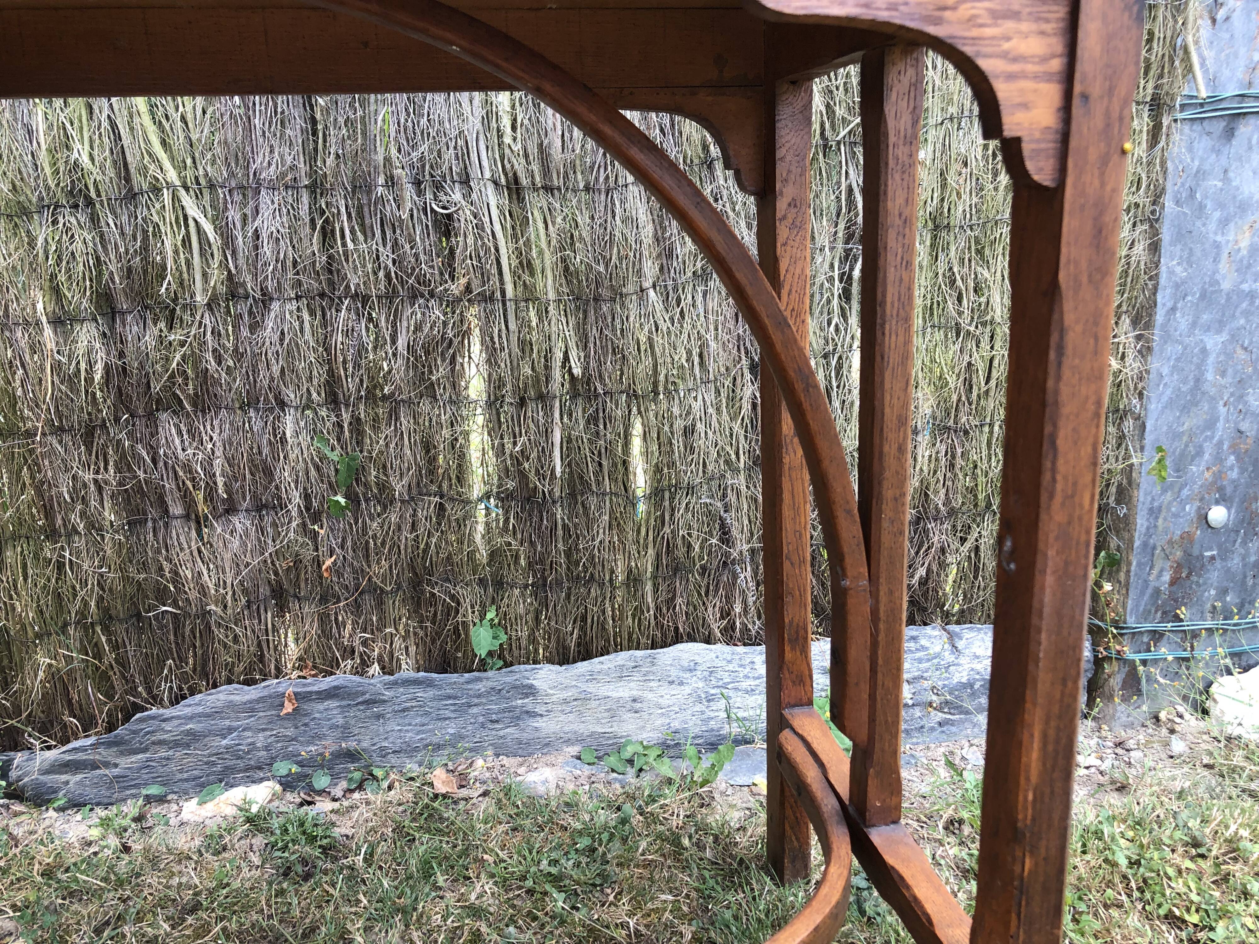Old oak desk with curved wooden sleepers in the Art Nouveau spirit of the early 20th century.