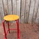 Vintage red industrial stool with a wooden seat, 1960s.
