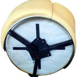 Pair of yellow leather swivel armchairs with asymmetrical armrests, circa 1980