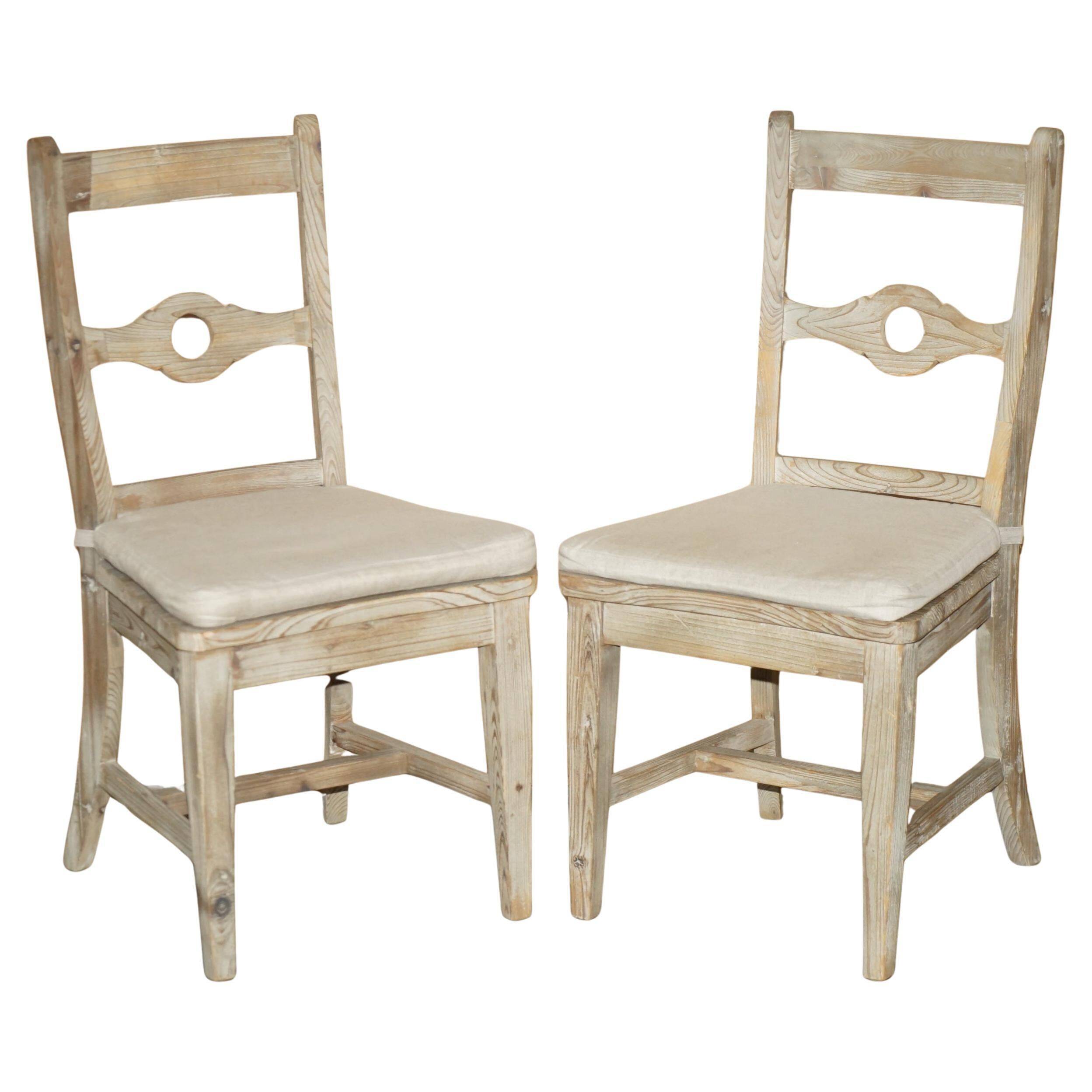 Pair of Swedish-style accent chairs in recycled pine with upholstered seats.