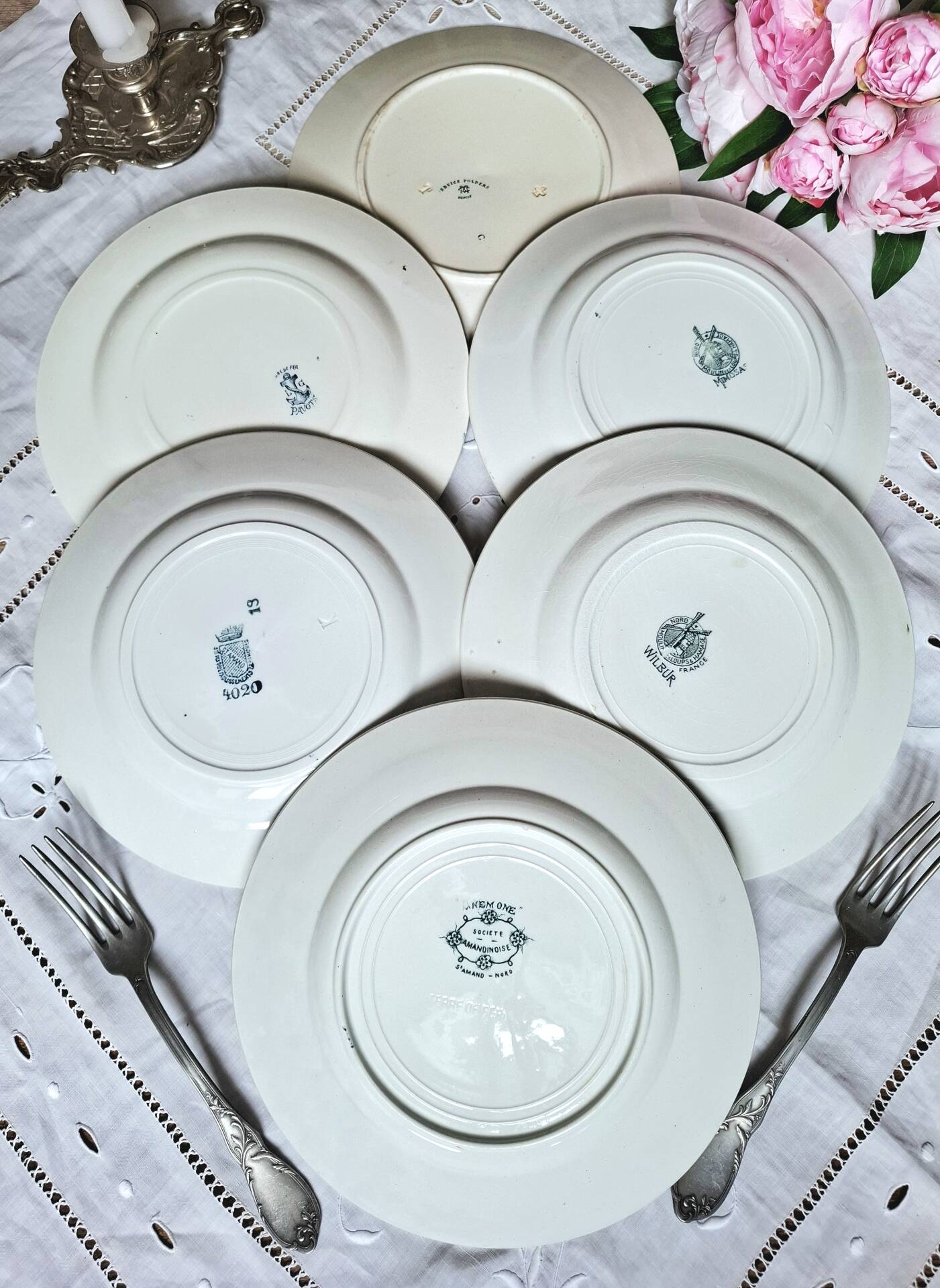 Old mismatched flat plates made of ironstone earthenware.