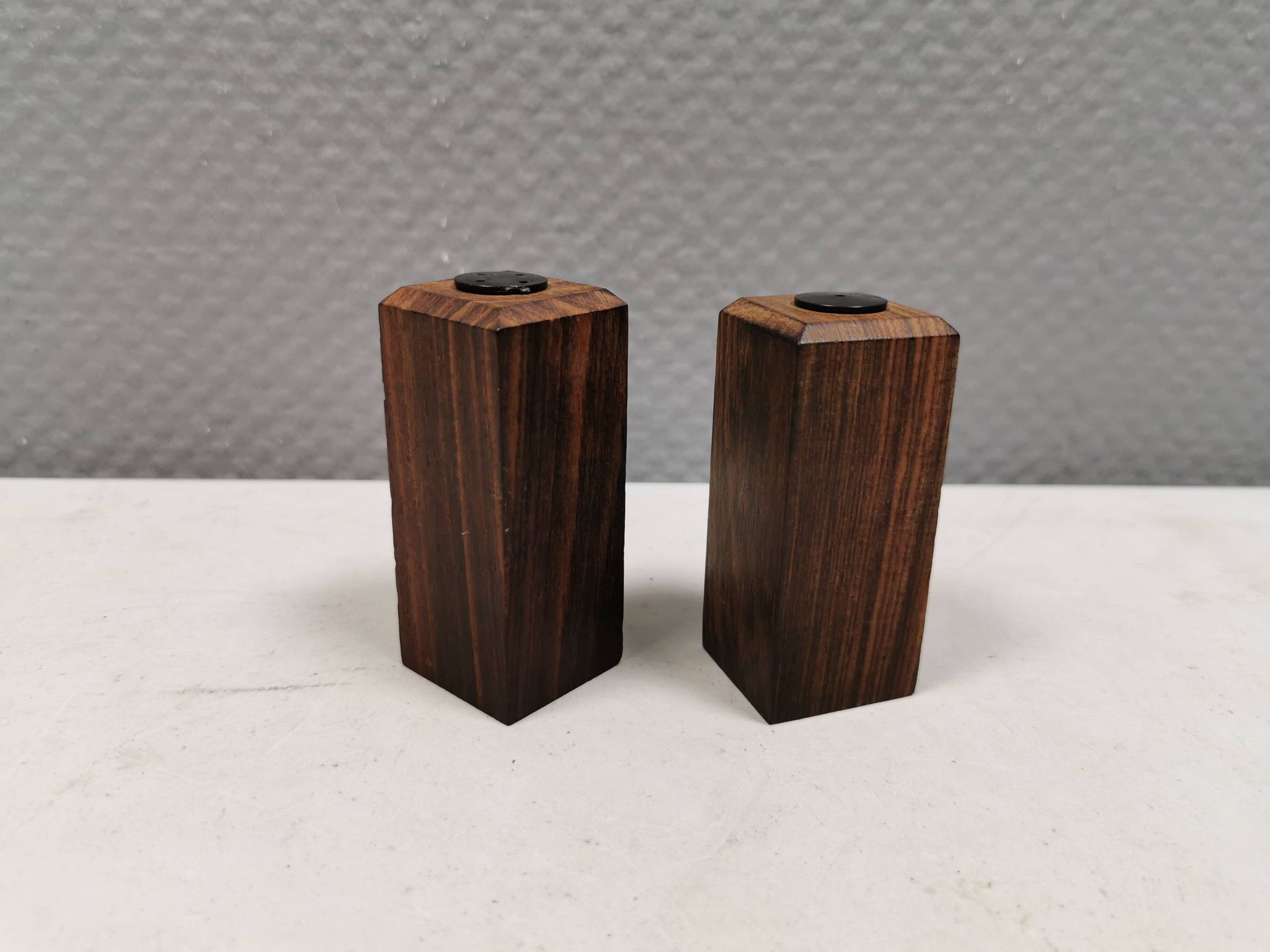 A set of salt and pepper shakers in rosewood