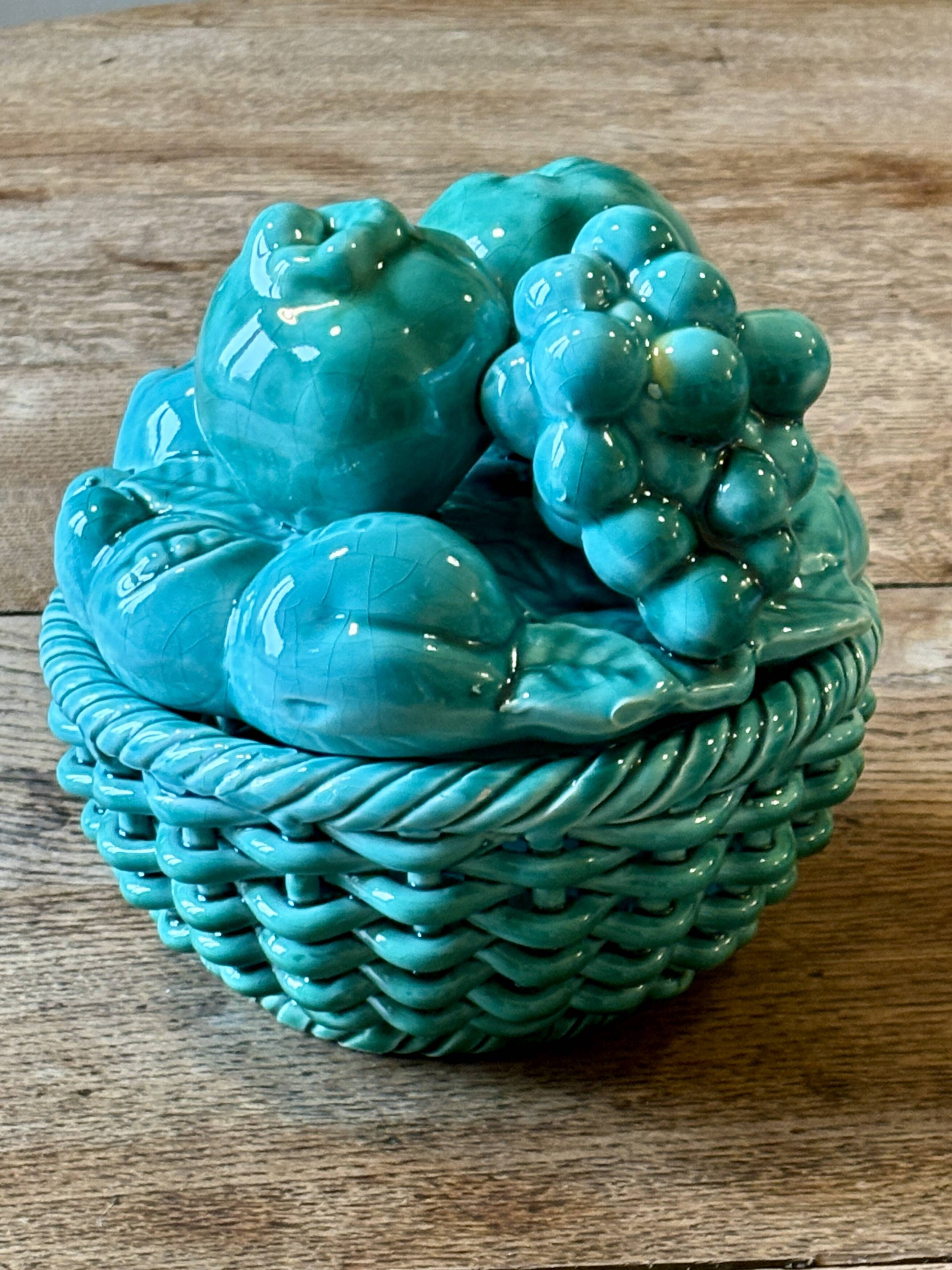 Vintage green earthenware plate/basket with fruit decorations.