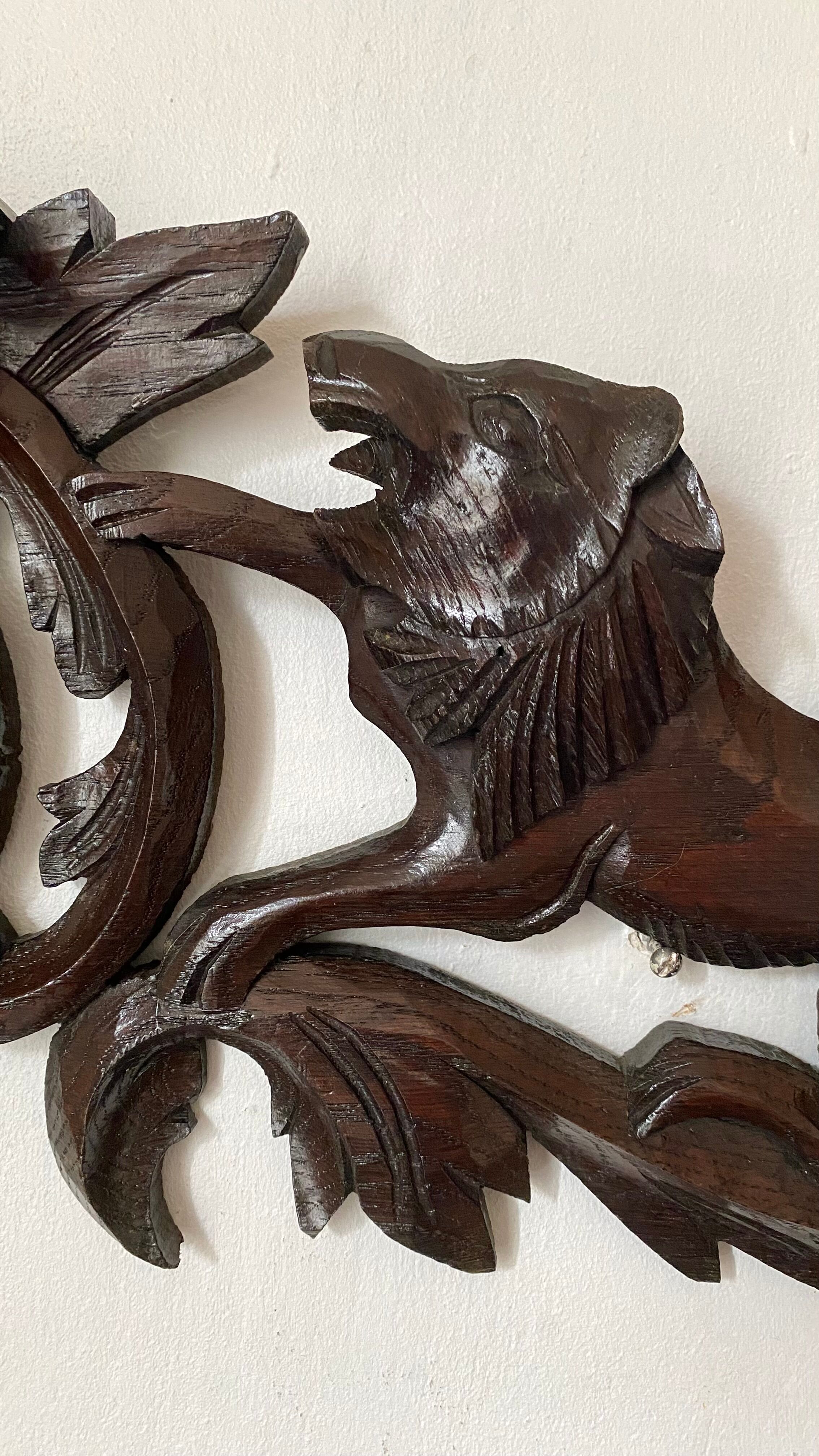 Antique carved wooden pediment with lions and medallion