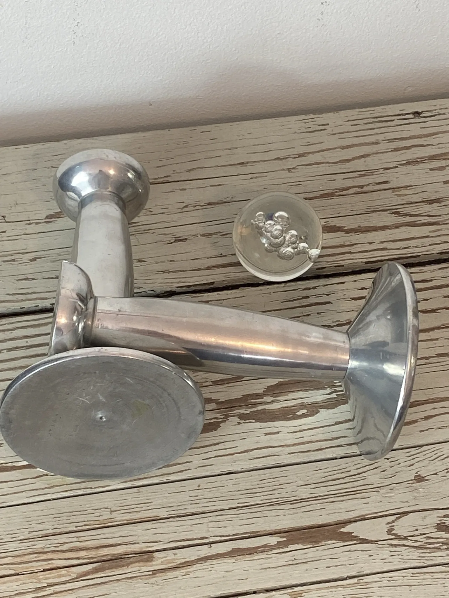 Pair of minimalist polished aluminium candle holders