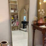 Long trapezoidal mirror in curved gilded brass, art deco modernist