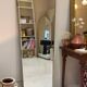 Long trapezoidal mirror in gilded brass, curved Art Deco modernist.