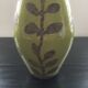 Large green vase with floral decoration
