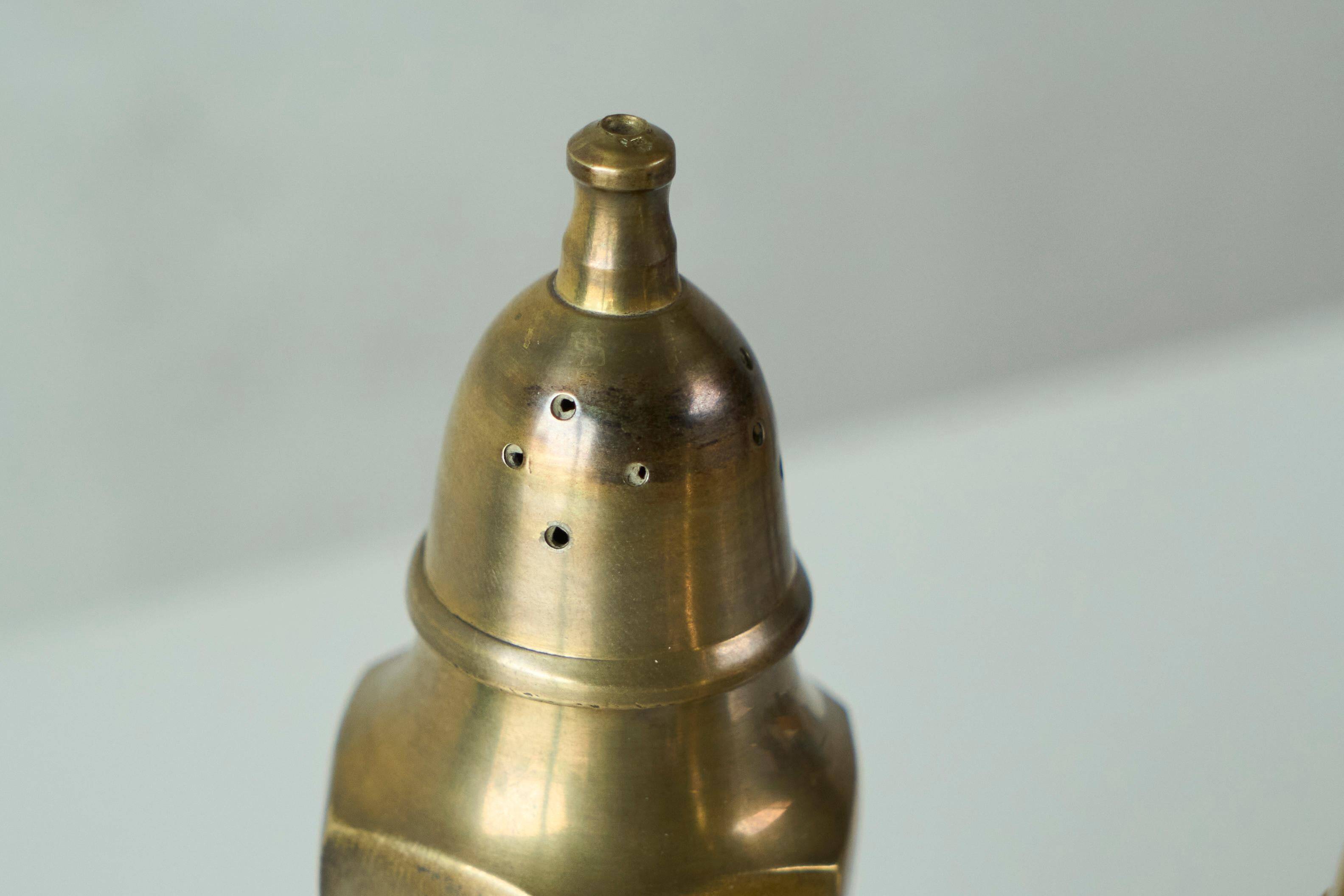 Pair of patinated brass salt and pepper shakers, 20th century.