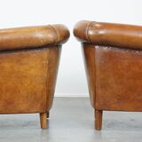 Set of 2 cognac-colored sheepskin club chairs with colorful fabric cushions