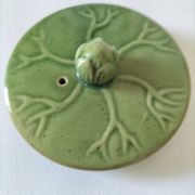 Vintage green teapot with lotus decoration and bamboo handle.