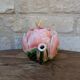 Ceramic teapot in the shape of a rose with a butterfly and raised petals.