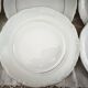 12 dessert plates in porcelain with double gold trim.