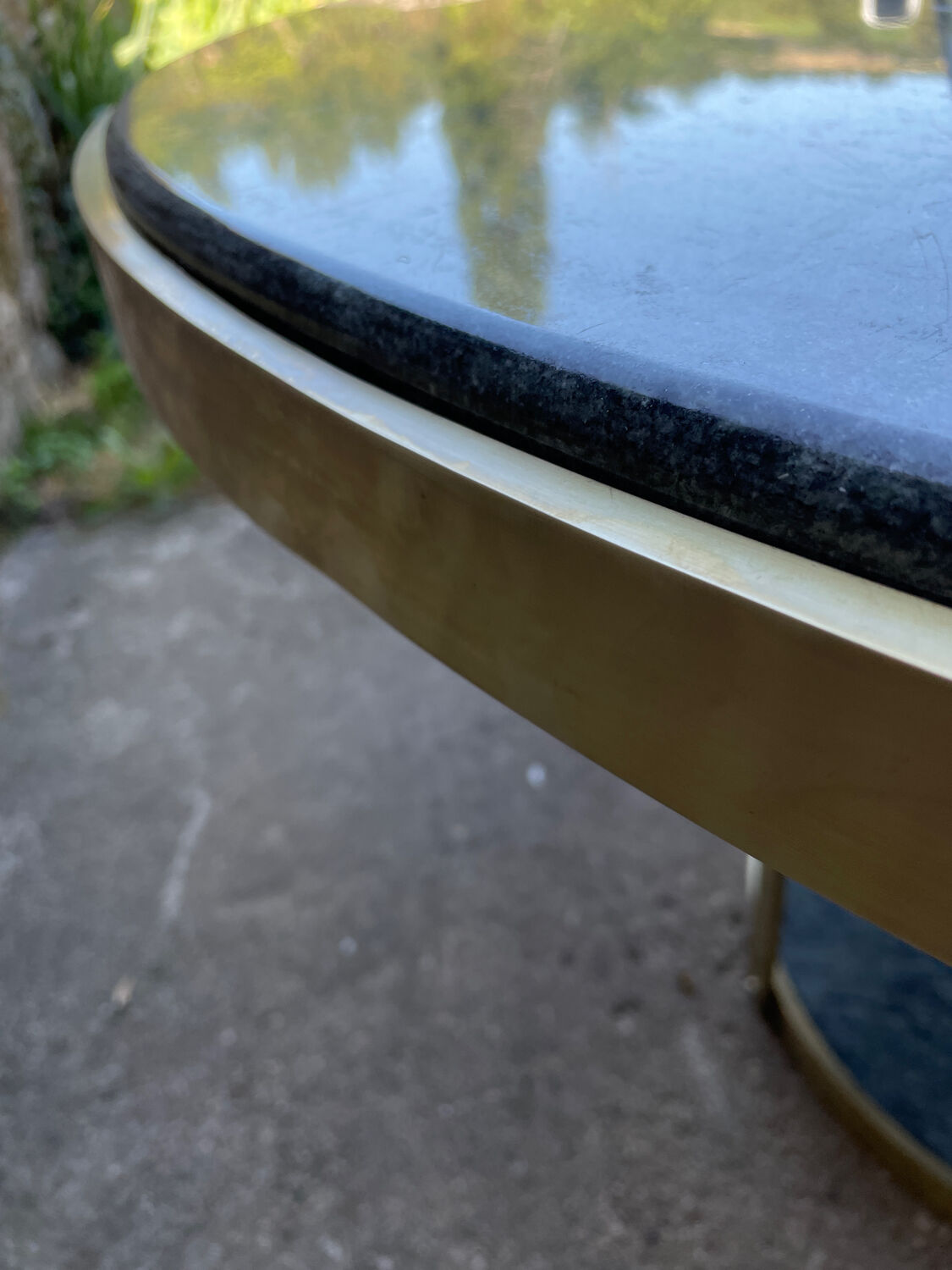 Round dining table with green marble and solid brass.