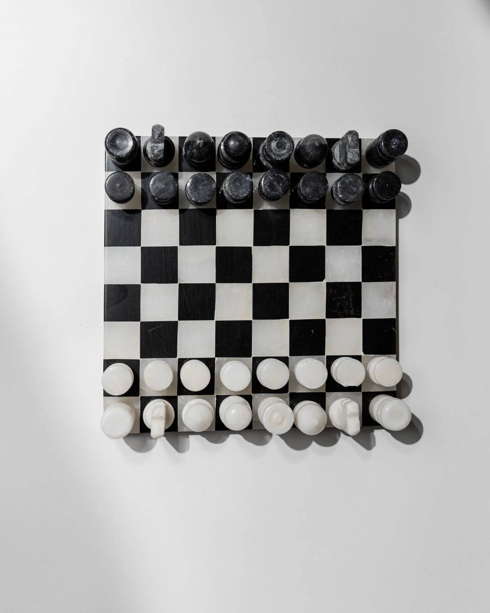 Vintage black-and-white marble chessboard with matching marble pieces, Italian 1960s design, sculptural centerpiece