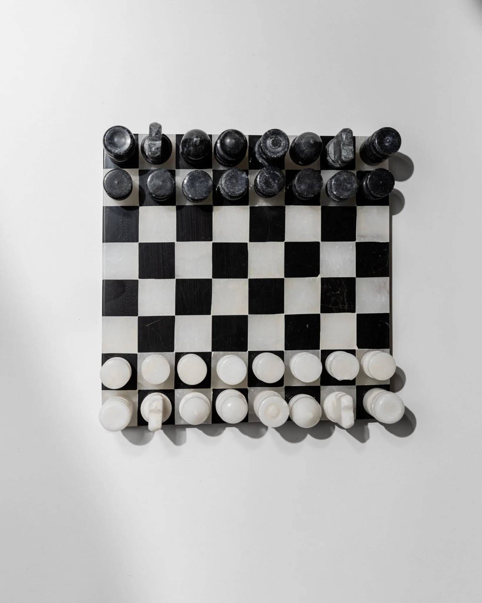 Vintage black-and-white marble chessboard with matching marble pieces, Italian 1960s design, sculptural centerpiece