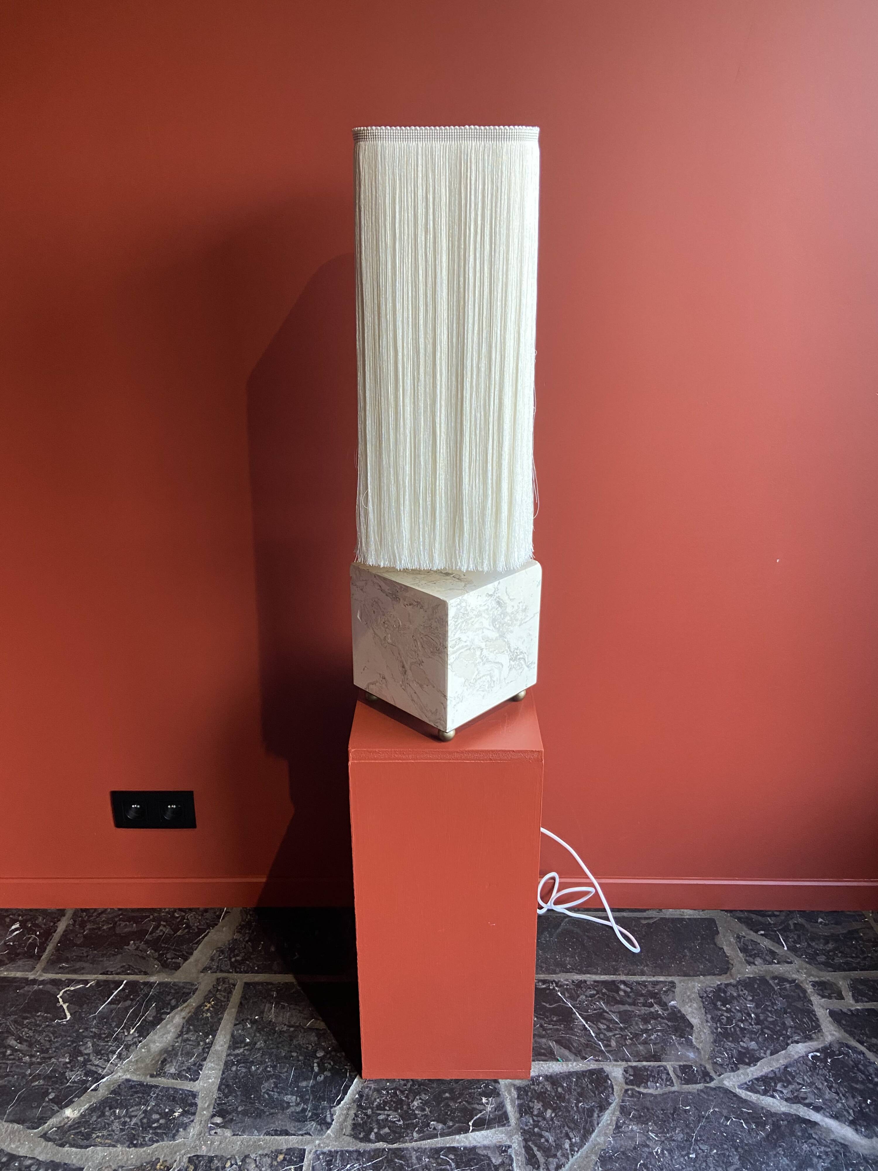 Beige marble stucco base, Houles white ecru fringed lampshade.