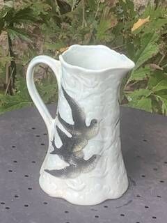 Jade green ceramic barbotine vase with swallows.