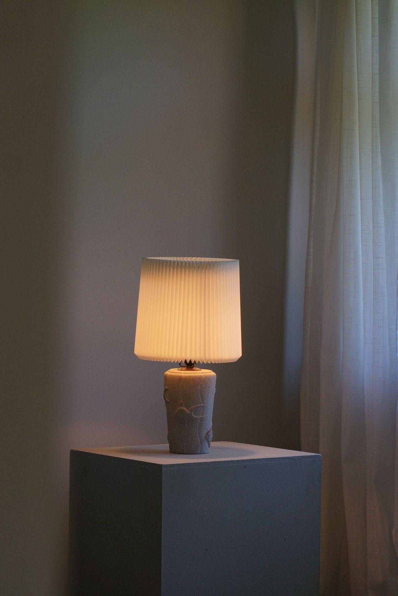 Modern vintage French table lamp, made of stone with fish patterns, 1970s.