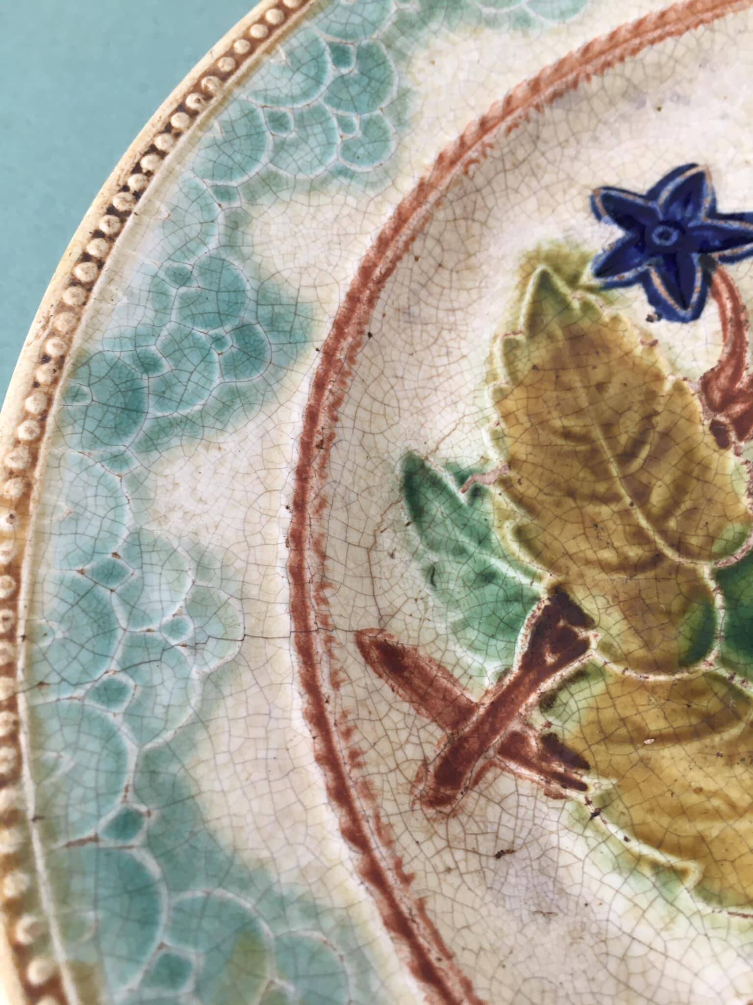 Old barbotine dessert plate. Floral patterns