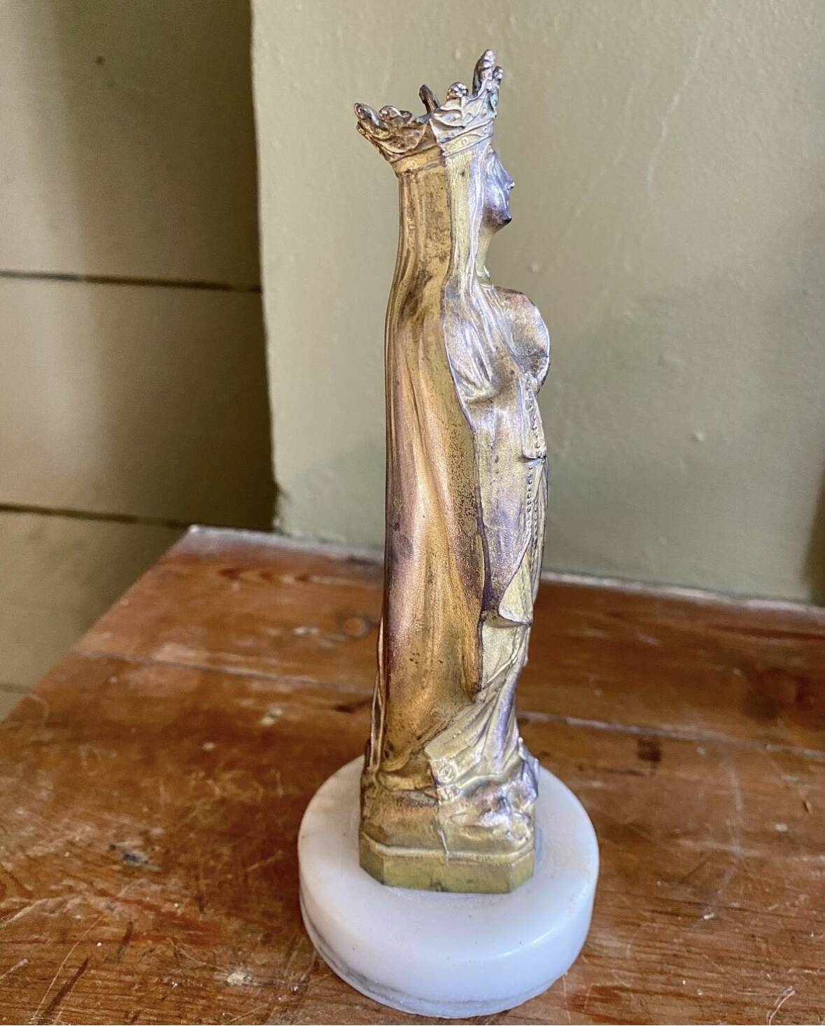 Virgin Mary crowned in metal and brass