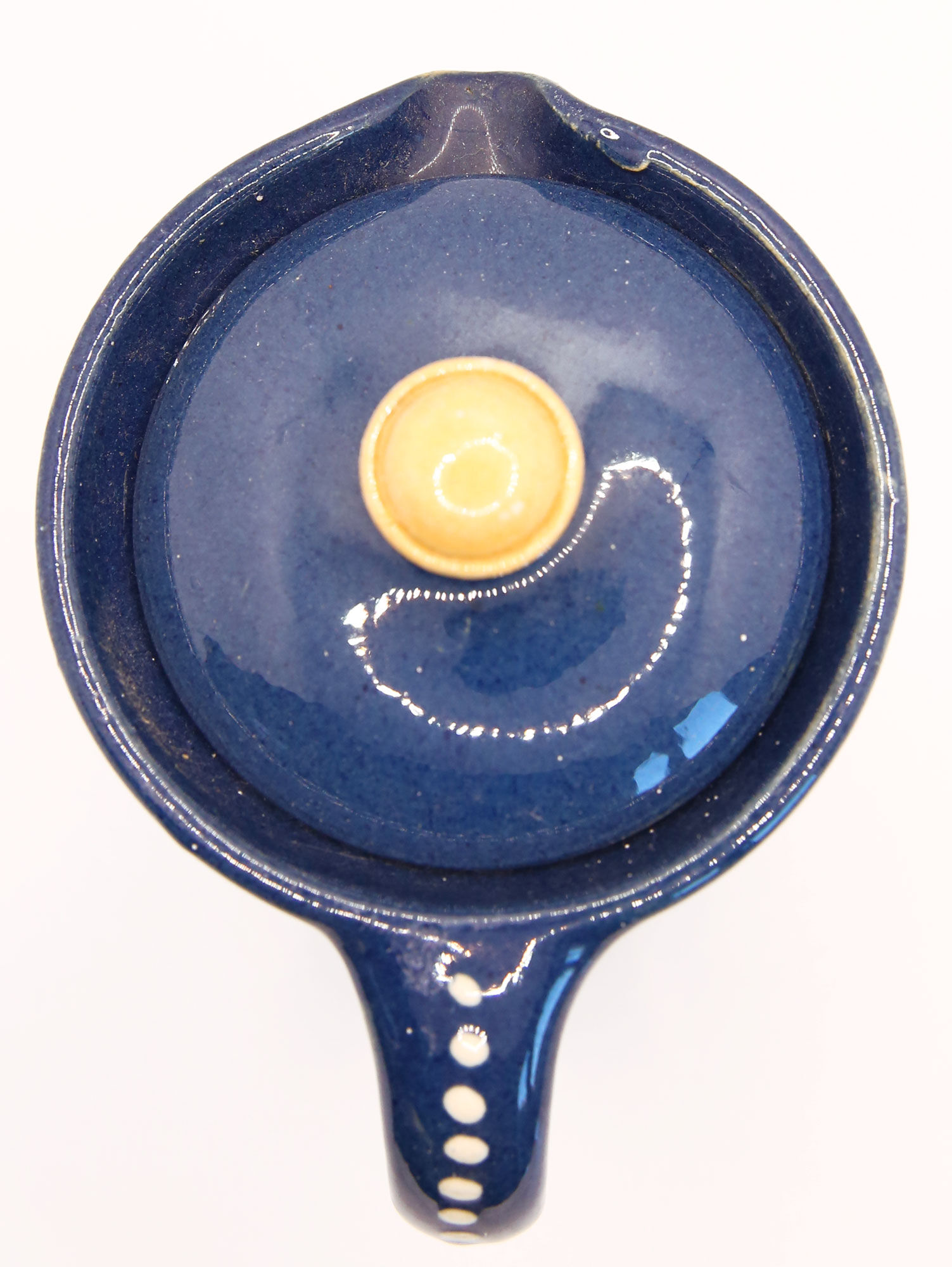 Pitcher and navy blue lid with off-white peas