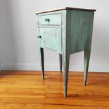Patinated bedside table end of sofa