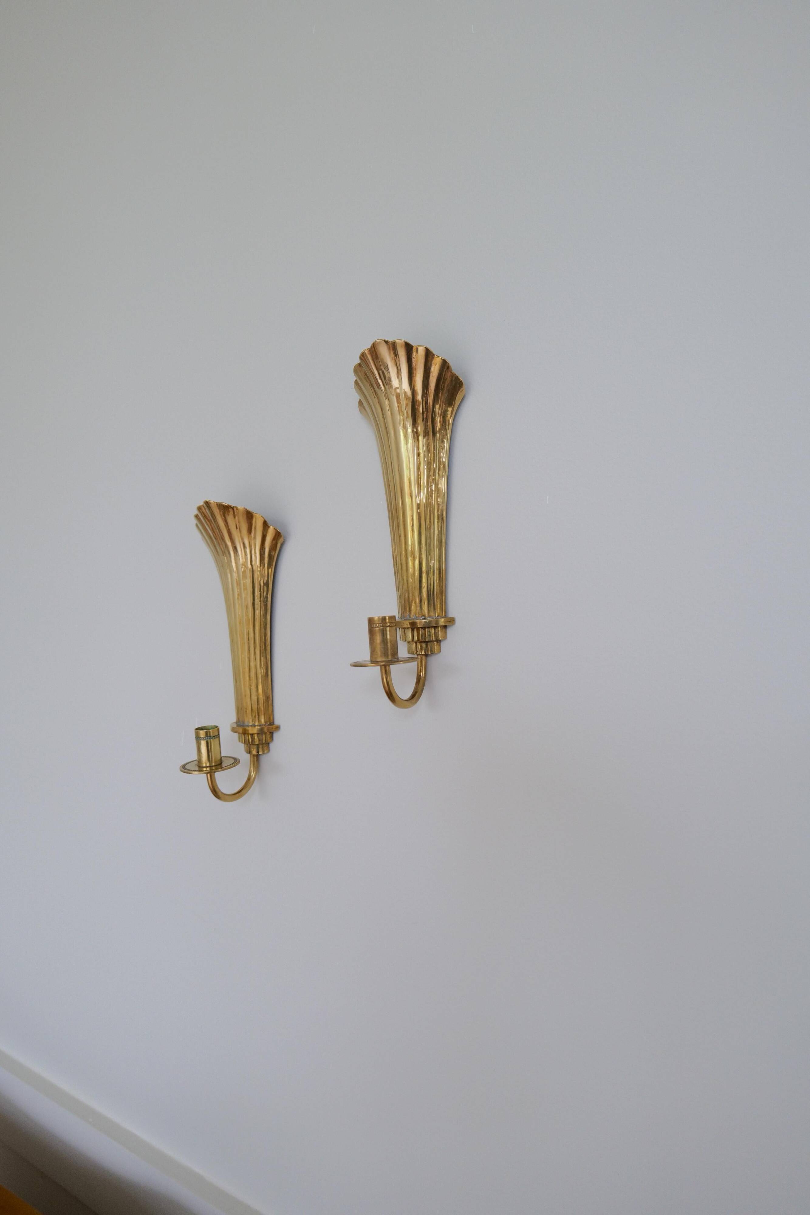 Pair of Art Deco brass wall sconces by Holmström, Arvika, Sweden, 1940s.