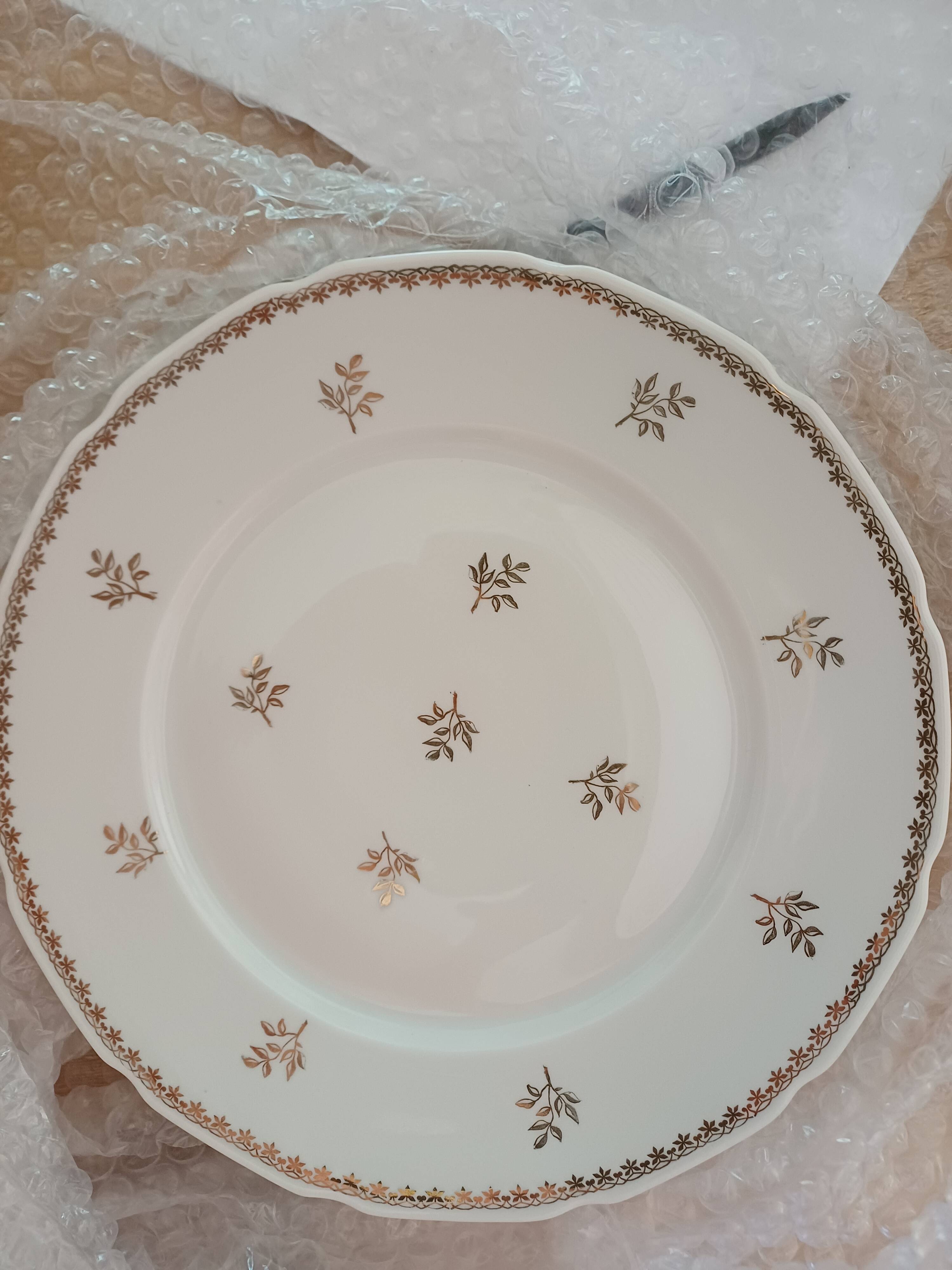 A lot of old white and gold porcelain plates T de F.