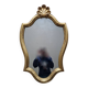 Carved and gilded wooden mirror, the pediment decorated with a shell.