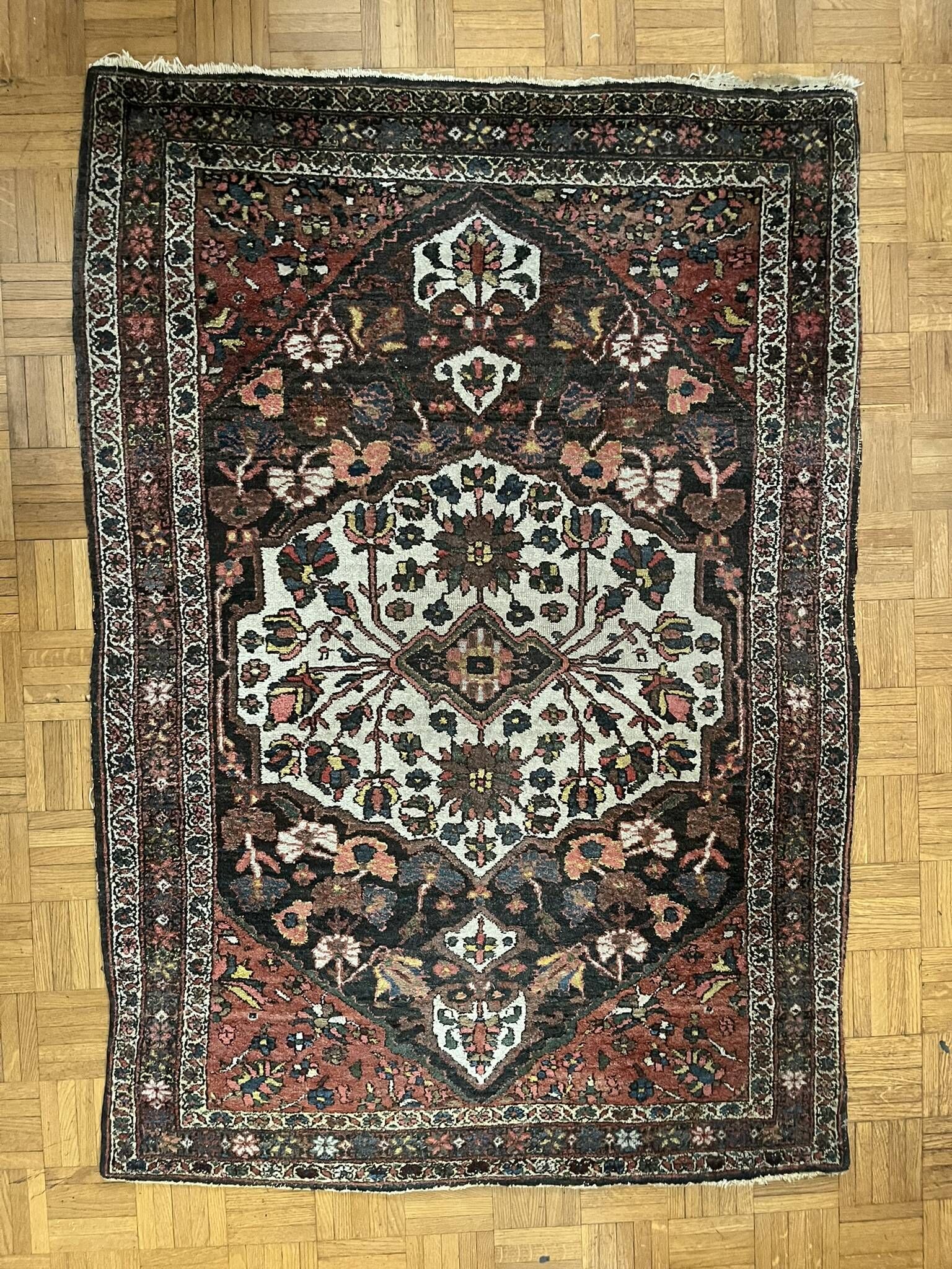 Antique handmade Hamadan Persian rug, ivory medallion on dark background 148x103.