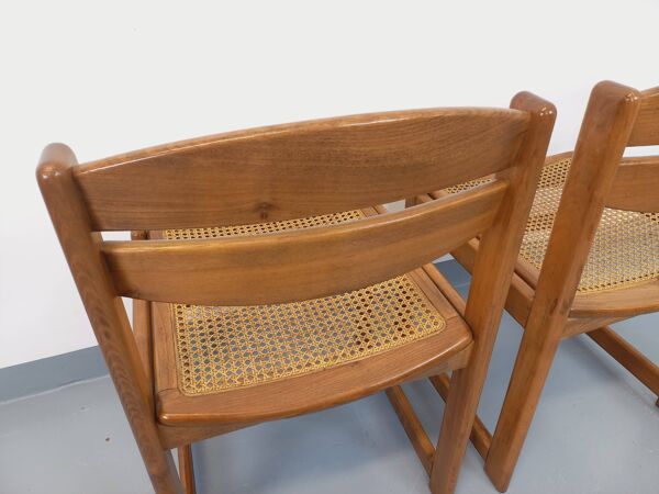 Paire de chaises traîneau vintage en bois de hêtre et cannage des années 70