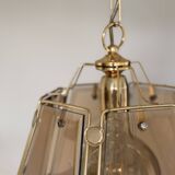 Pair of vintage pendant lights in smoked glass and gold metal, Hollywood style.