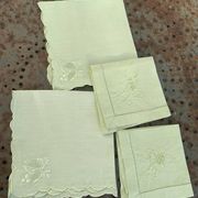 4 small tea towels, mismatched in linen, embroidered, two with flowers and two with fishermen