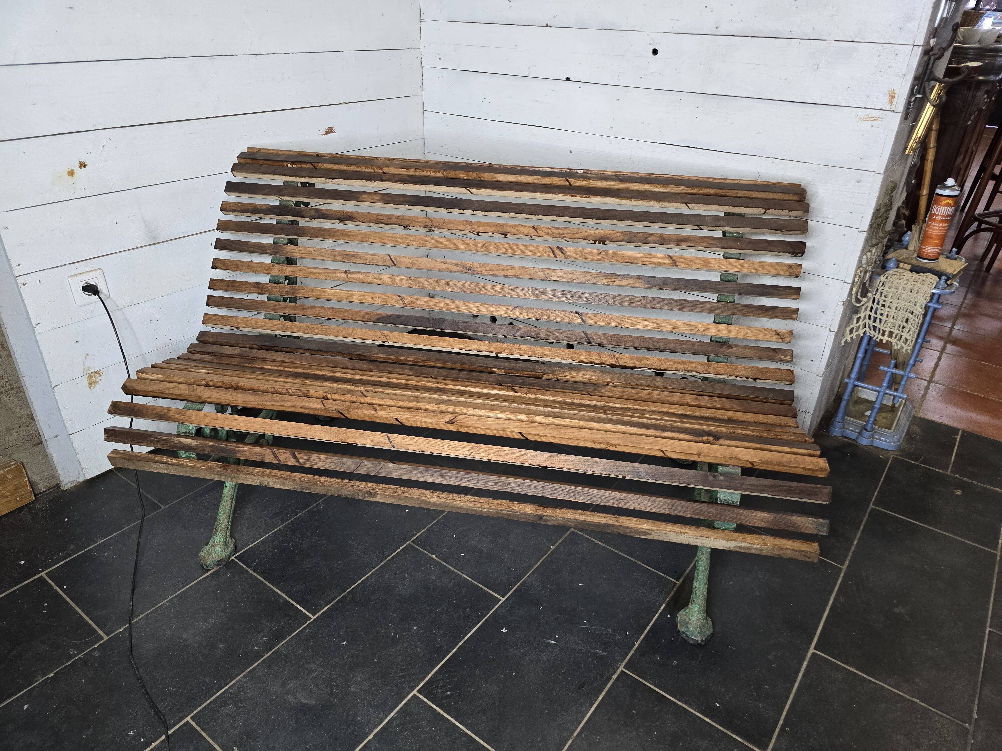 Old cast iron garden bench with oak slats