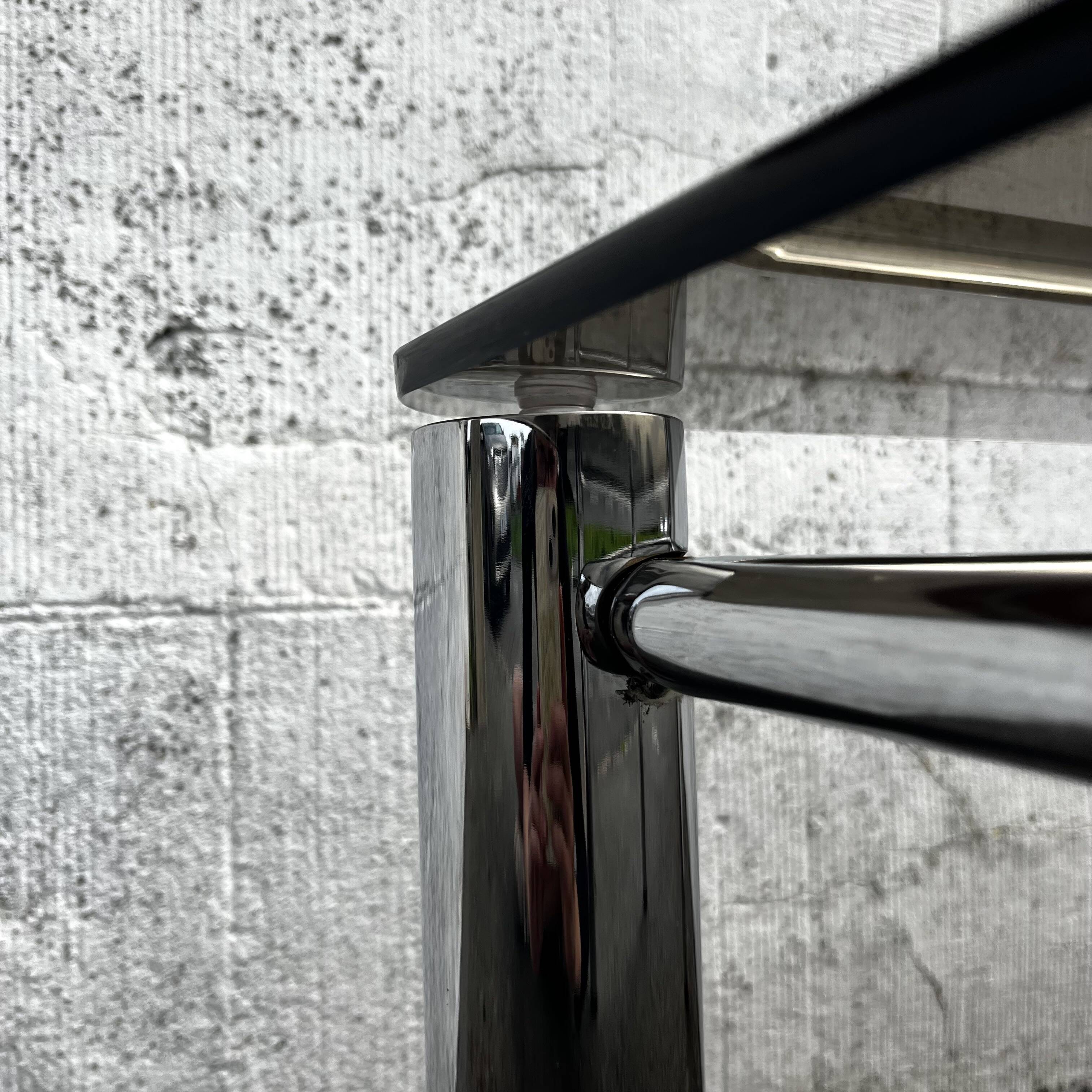 Vintage smoked glass coffee table with chrome structure.