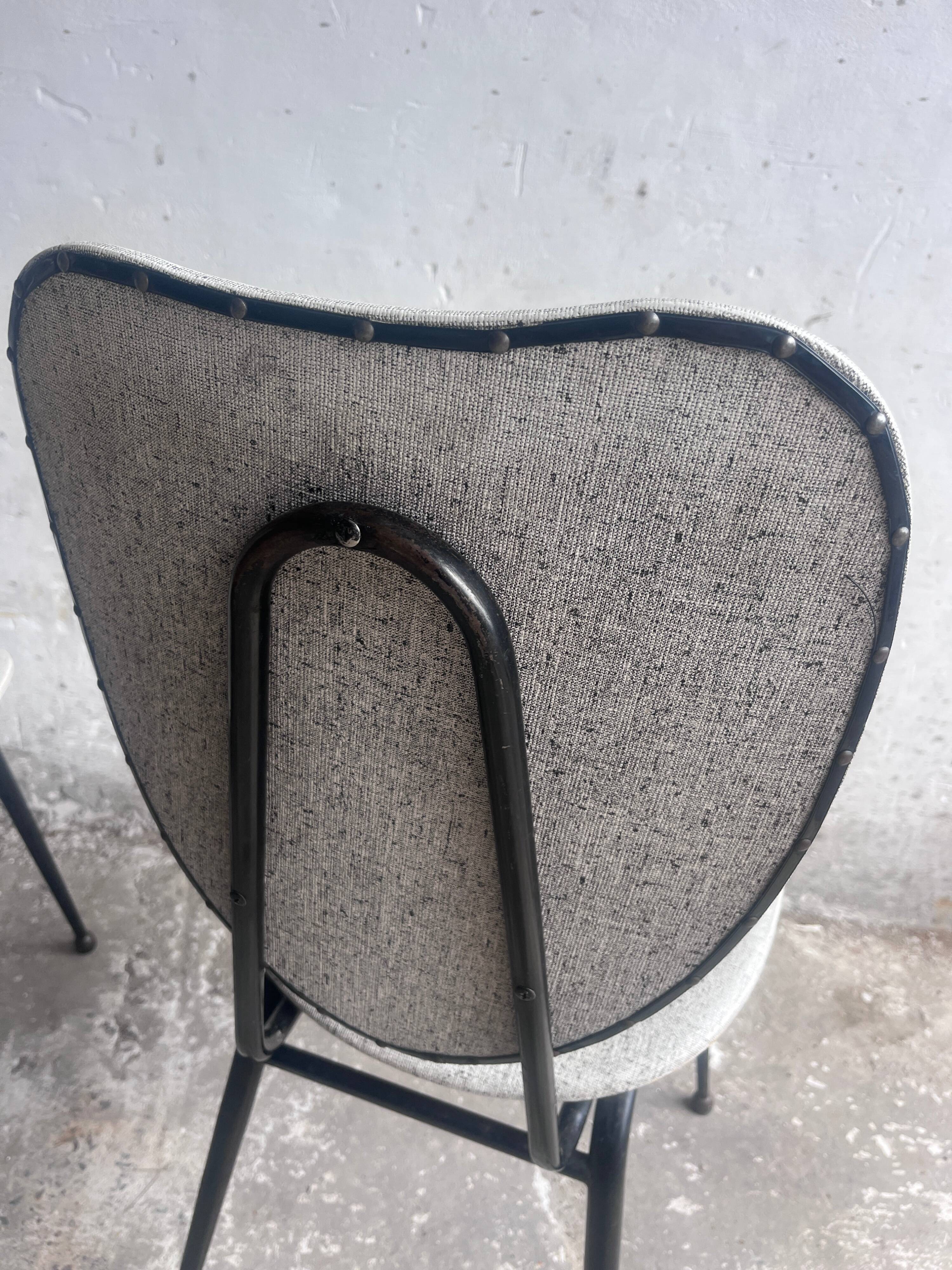 Elegant pair of French dining chairs by Jacques Hitier from the 1950s.