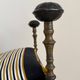 Seduta d’epoca anni 1920–1930 in ferro battuto, ottone e pelle .