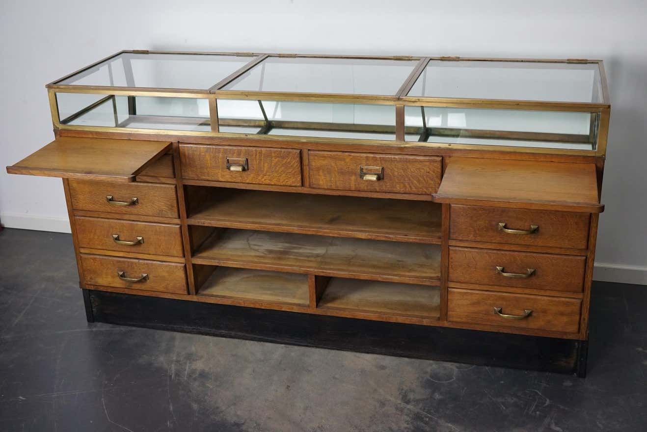 Counter or shop window in oak glass and brass France around 1920
