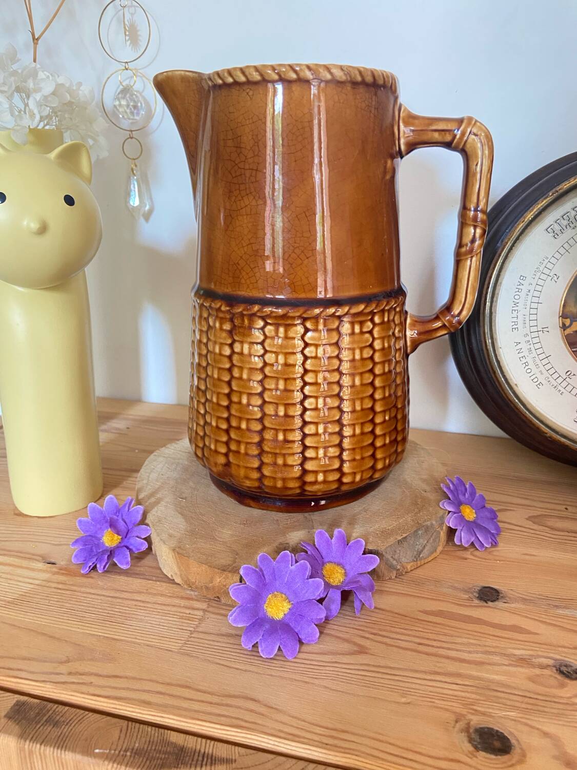 Antique vintage ceramic pitcher or jug from Sarreguemines, France. Brown with a pink interior, imitation basket.