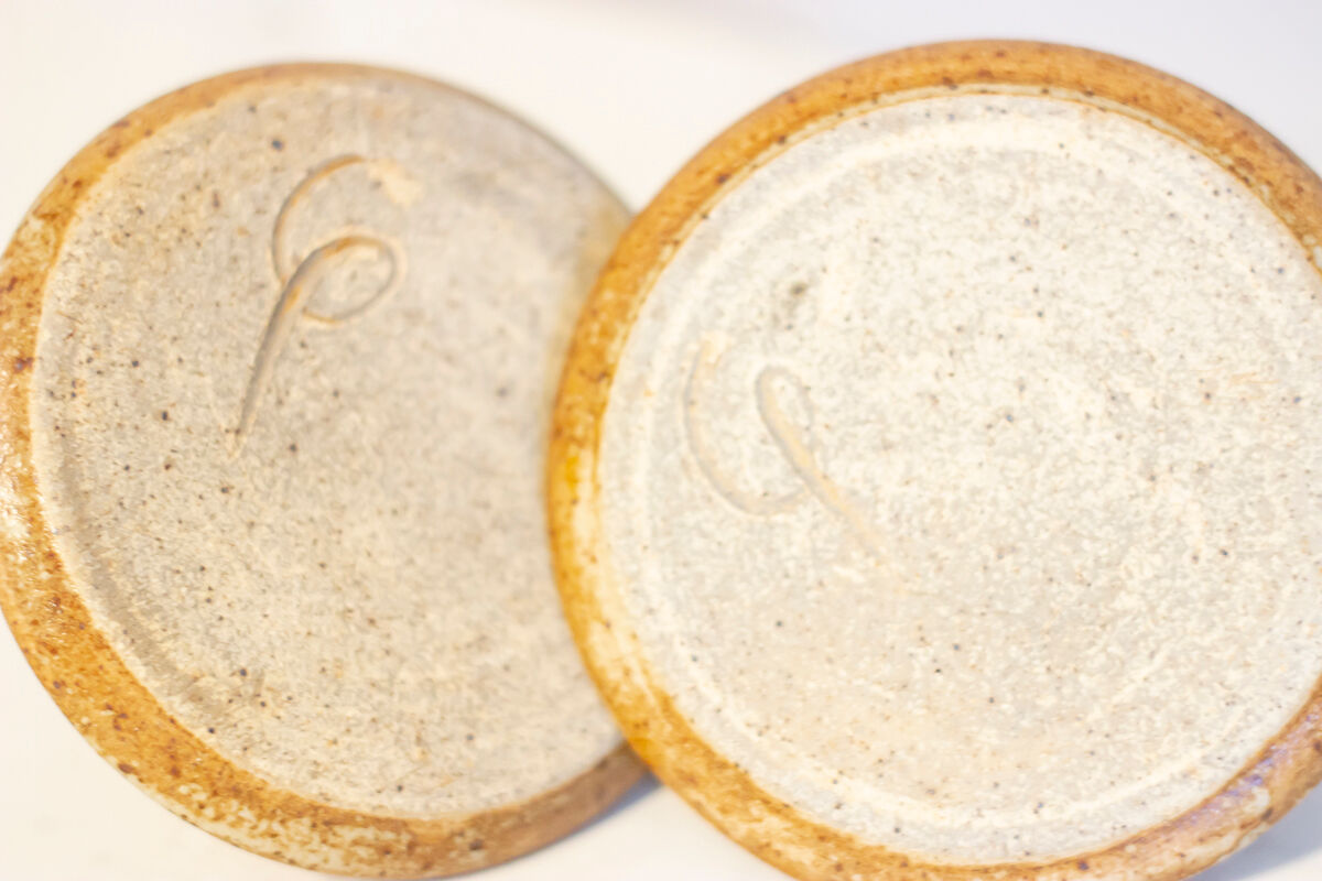 2 stoneware shells, unidentified signature