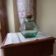 Old thick glass of a light green jar